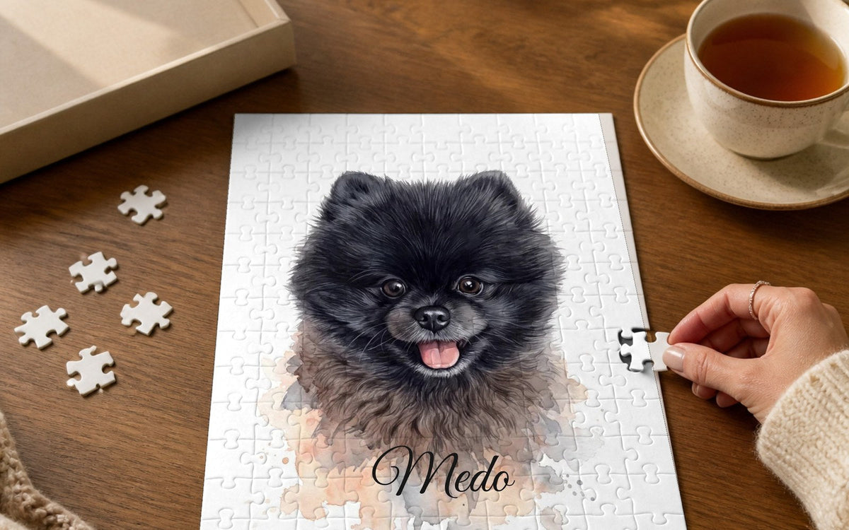 Jigsaw puzzle with a watercolour portrait of a black Pomeranian on a wooden table